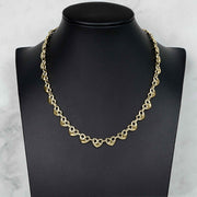 10k gold classic puff heart Gucci link chain necklace displayed on a black jewelry mannequin bust.