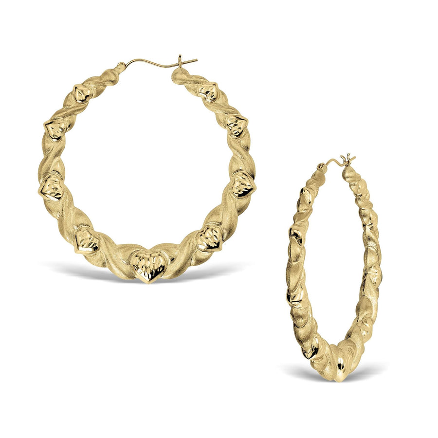 Two twisted round 10k yellow gold heart-themed hoop earrings on a white background.