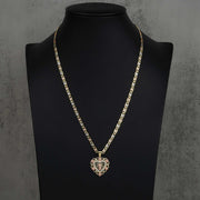 Two-tone San Judas heart pendant on a gold chain, displayed on a black jewelry bust.