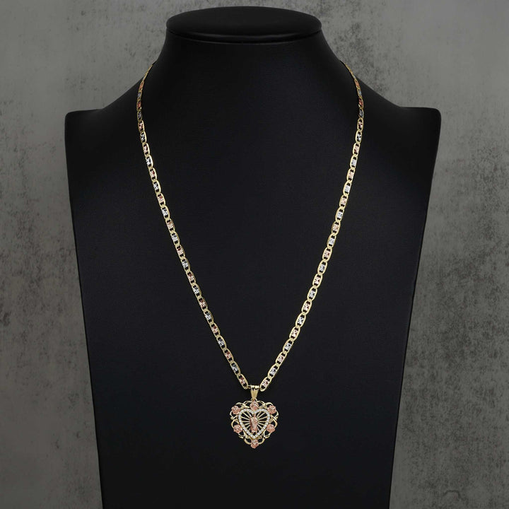 Two-tone San Judas heart pendant on a gold chain, displayed on a black jewelry bust.