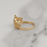 Side view of two-tone gold quinceañera crown ring with cubic zirconia detailing on marble.