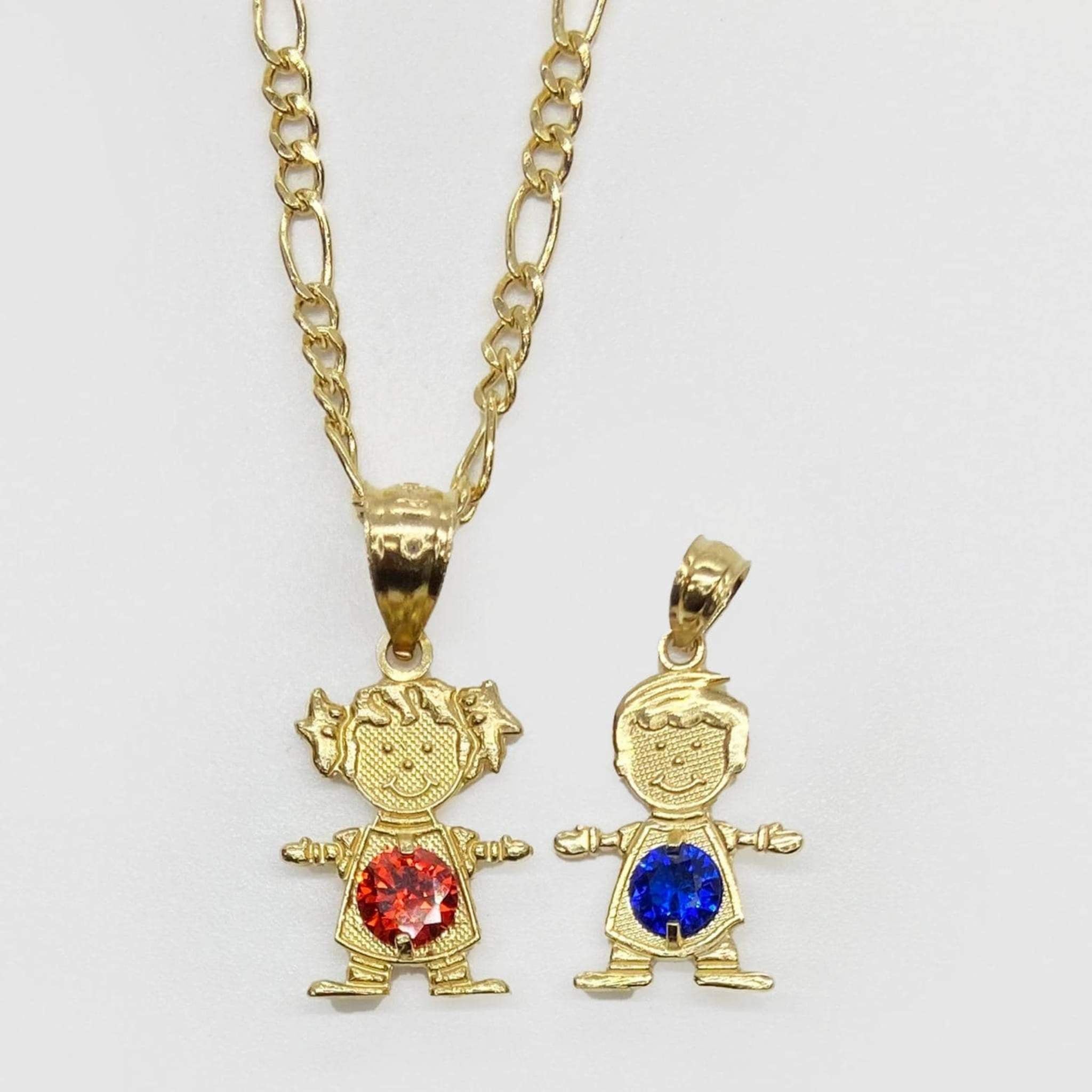 Yellow gold boy and girl pendants with blue and red gemstones on white background.