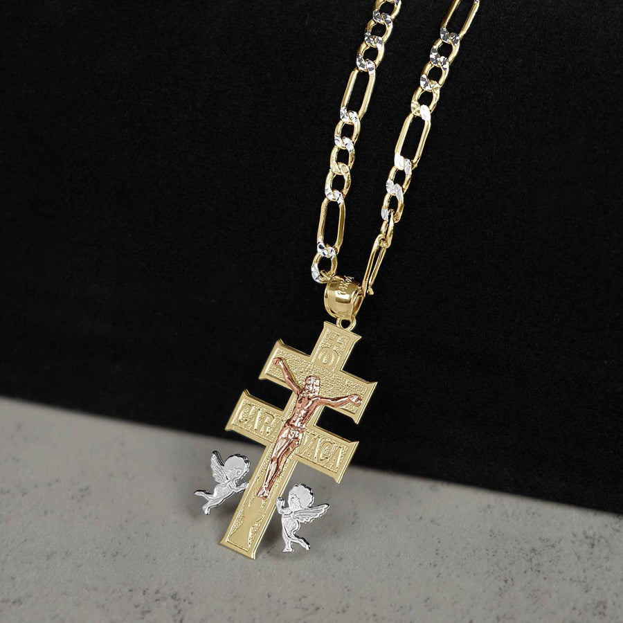 Gold Caravaca crucifix cross pendant with rose gold Jesus figure on a figaro chain.