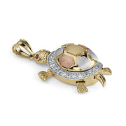 Close-up of a 10k and 14k gold open-back turtle charm on white