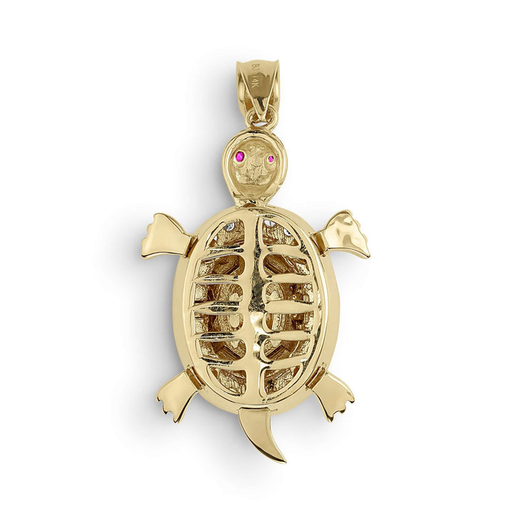 gold turtle pendant featuring an open-back textured shell and pink gemstone eyes