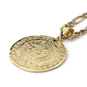 Gold Aztec calendar pendant featuring a detailed circular engraving attached to a link chain.