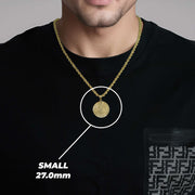 Man in black shirt showcasing a small gold pendant necklace with size text.