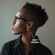 Side profile of a woman wearing 20mm 10k gold classic bamboo heart hoop earrings.