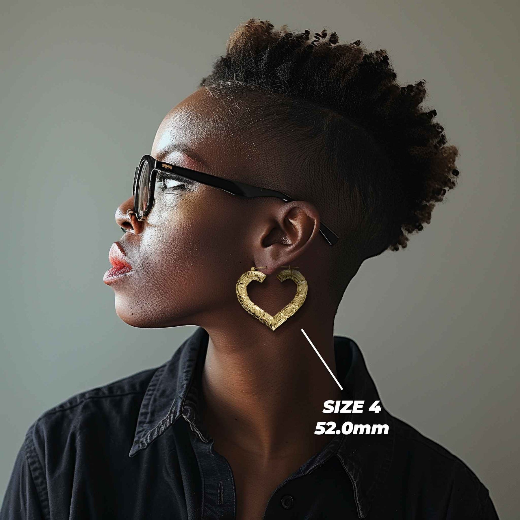 Side profile of a woman wearing 52mm 10k gold classic bamboo heart hoop earrings.