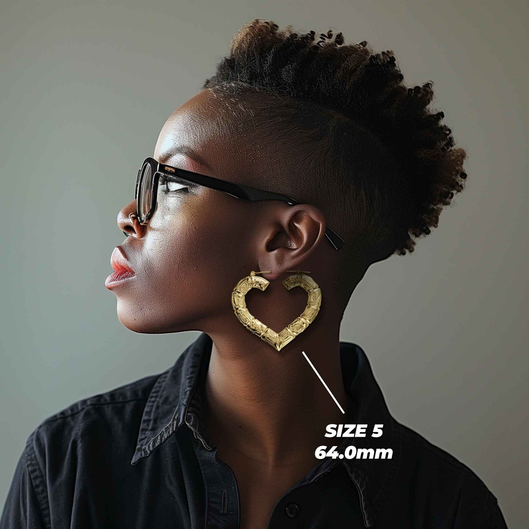Side profile of a woman wearing 64mm 10k gold classic bamboo heart hoop earrings.