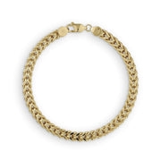 Overhead view of a yellow gold hollow Franco link bracelet in a circle