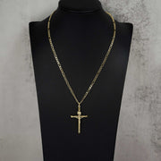 Gold INRI crucifix pendant on a Figaro chain displayed on a black bust.