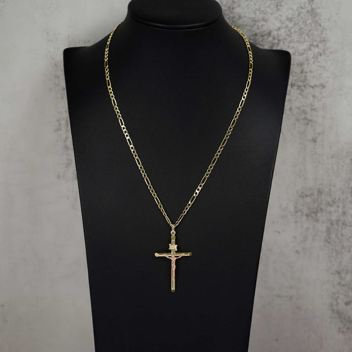 Two-tone gold and rose gold tubular INRI crucifix pendant and chain on a mannequin bust.