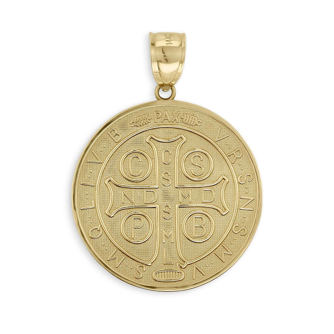 Close-up of a round gold Saint Benedict medal pendant featuring a detailed cross and Latin inscriptions.