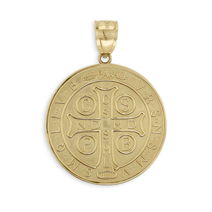 Close-up of a round gold Saint Benedict medal pendant featuring a detailed cross and Latin inscriptions.