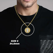 A man wearing a two-tone gold Saint Benedict pendant on a chain with text overlay reading SIZE 5 34.0mm.