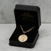  10k 14k solid yellow gold Saint Benedict round pendant on a black jewelry box with Nolters Gold logo 