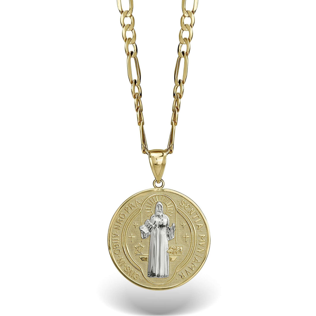 Two-tone gold Saint Benedict medal pendant on a gold link chain against white.