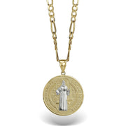 Two-tone gold Saint Benedict medal pendant on a gold link chain against white.