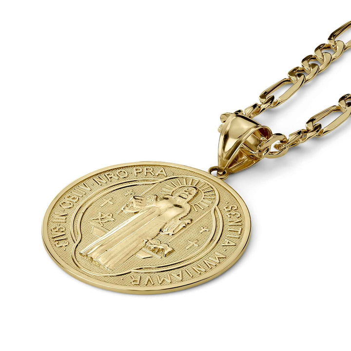 A gold Saint Benedict medal pendant angled on a matching chain against a white background.