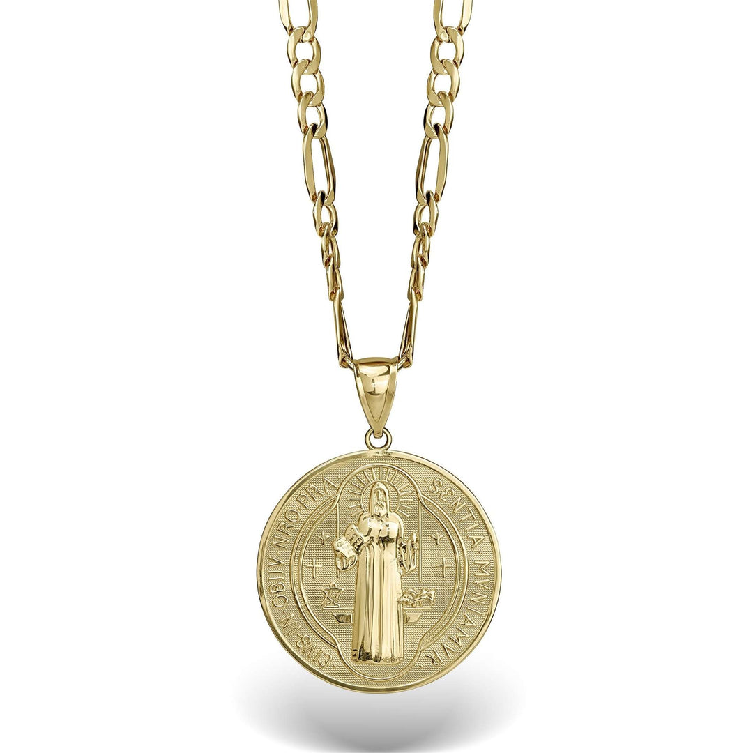 Close-up of a gold Saint Benedict medal pendant showing the detailed central figure and cross.