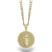 Close-up of a gold Saint Benedict medal pendant showing the detailed central figure and cross.