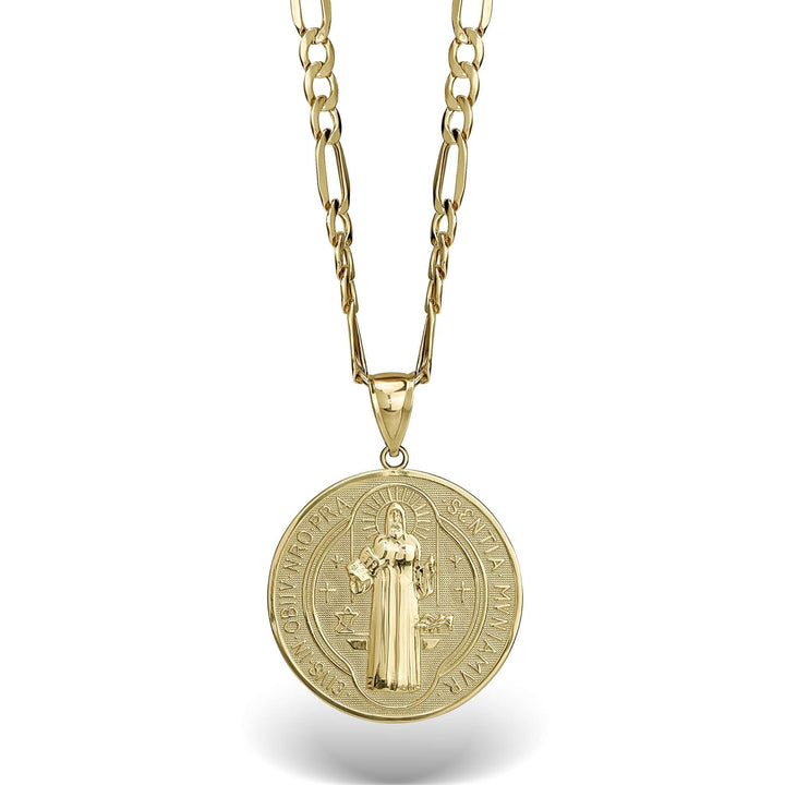 Close-up of a gold Saint Benedict medal pendant showing the detailed central figure and cross.