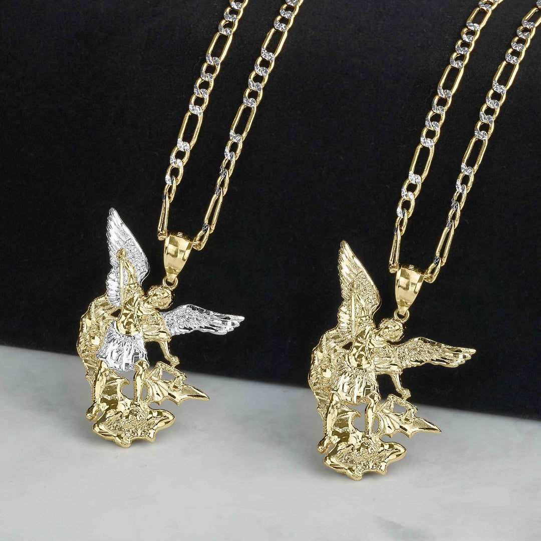 Two gold Saint Michael pendants hanging on chains, one featuring white gold wings.