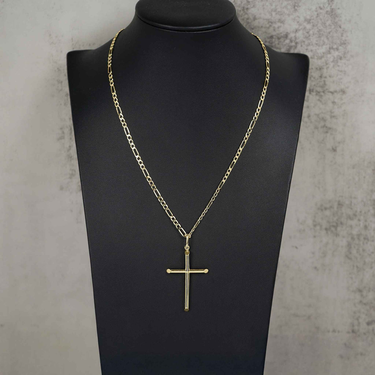 10k yellow gold tube cross pendant necklace displayed on a black mannequin.