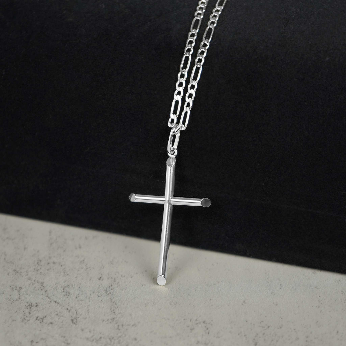 Polished white gold tube cross pendant necklace styled on a delicate paperclip chain.