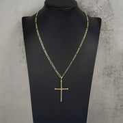 Yellow gold tube cross necklace on a black mannequin against textured gray background.