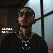 Man wearing the Small Last Supper gold pendant with a 26.0mm size label.
