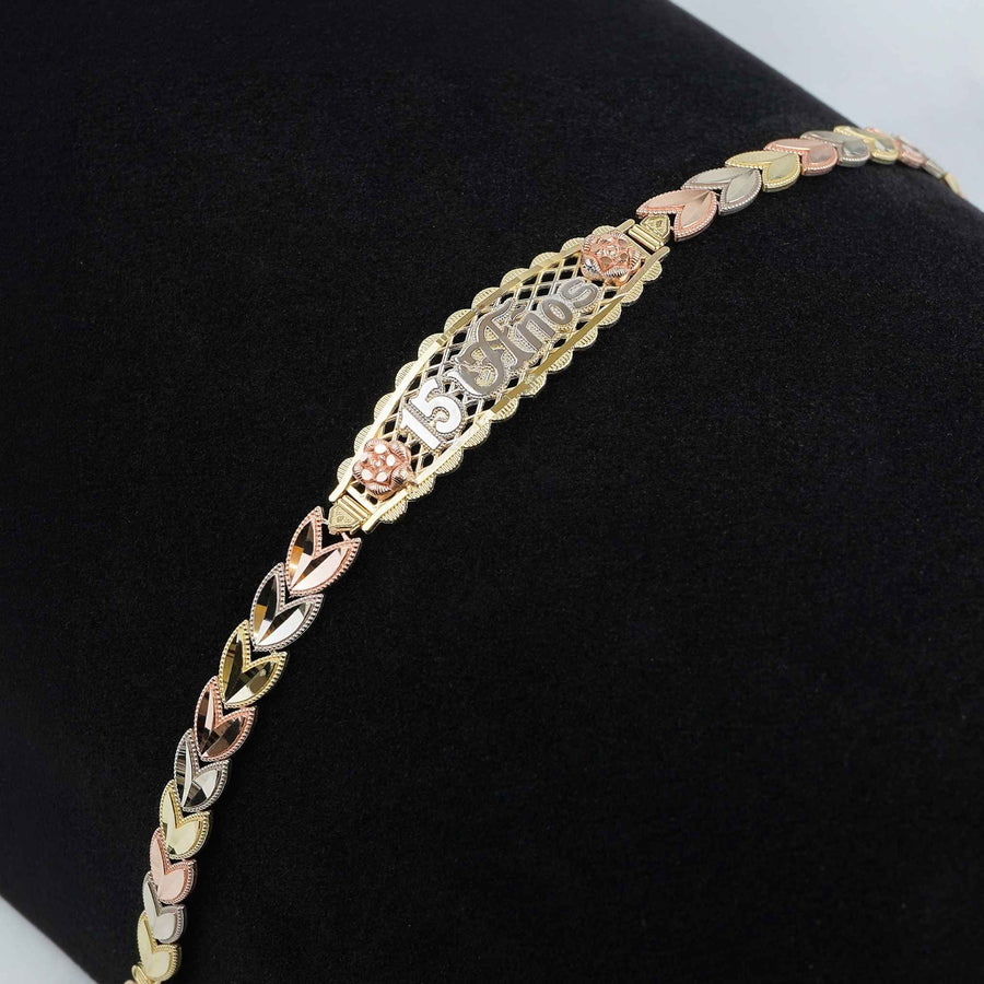 Tri-color gold Quinceañera "15 Años" leaf link bracelet displayed on dark background