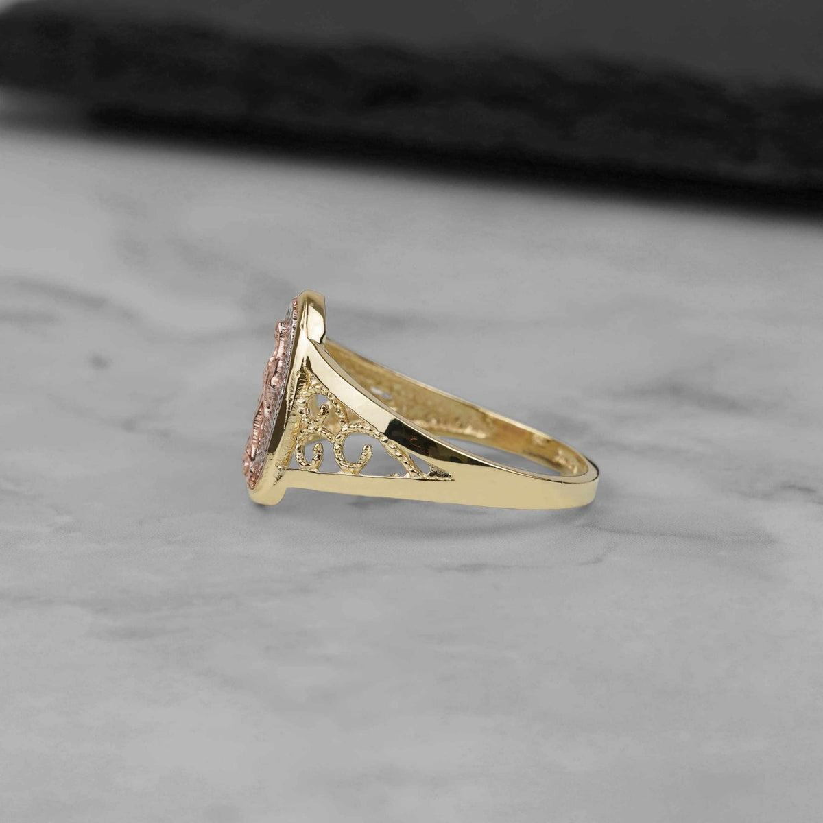 Side profile of the 10k and 14k gold Alvia Virgin Mary ring.