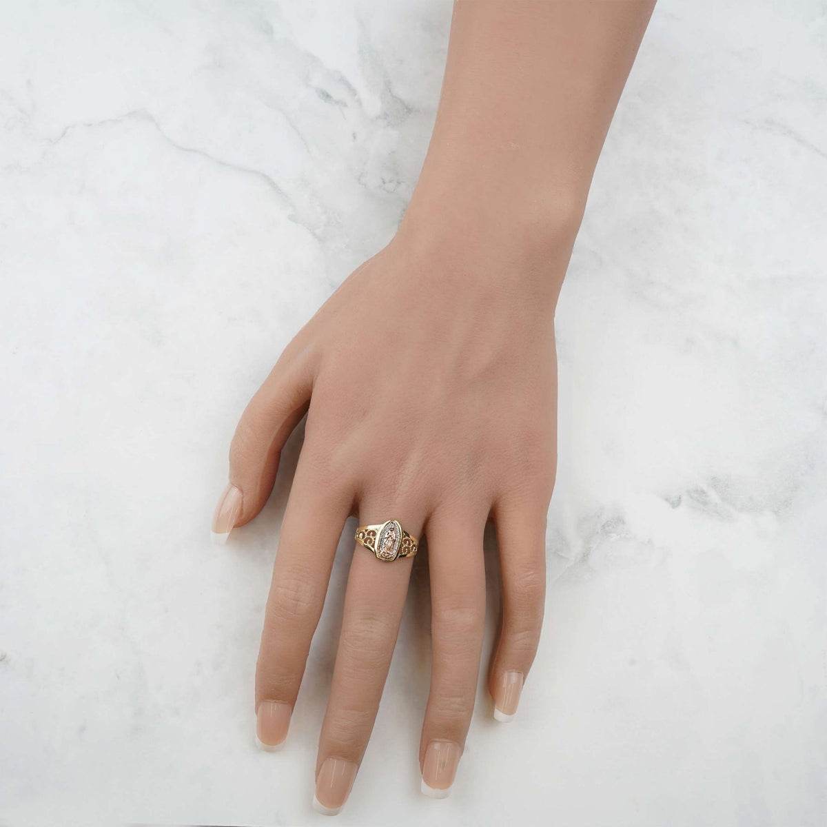Hand wearing the 10k and 14k gold Alvia pointed oval Virgin Mary ring.