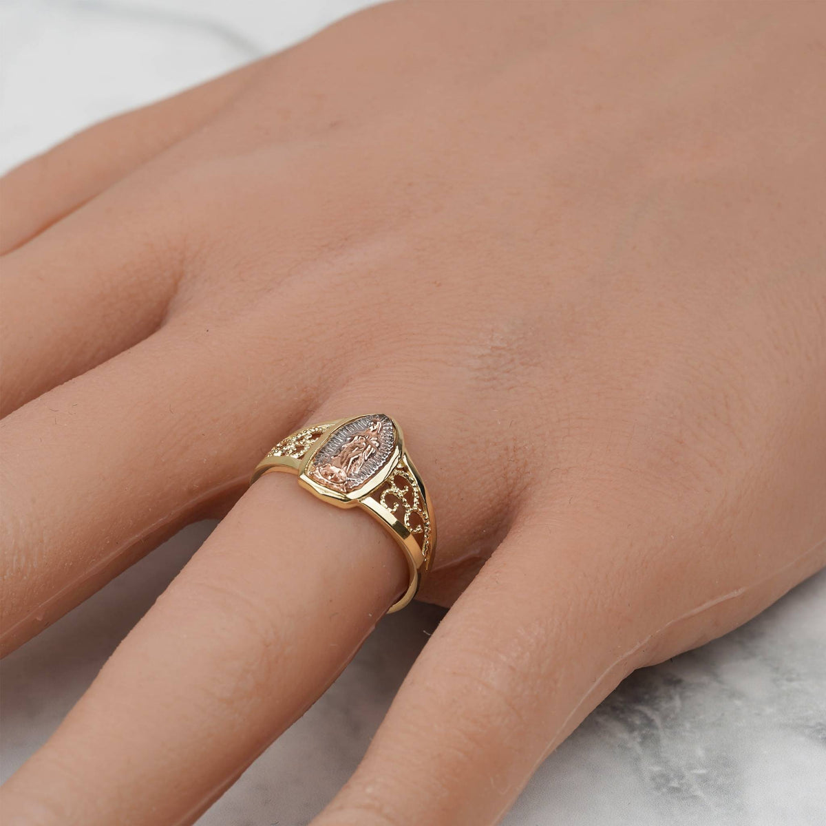 Hand wearing the 10k and 14k gold Alvia Virgin Mary ring.