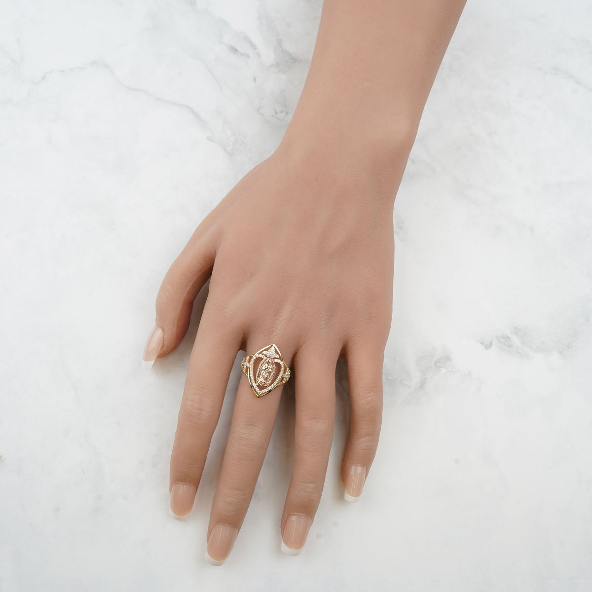 Overhead view of a hand wearing the 10k and 14k gold marquise Virgin Mary ring.