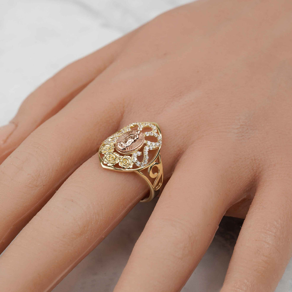 Angled hand view showcasing the 10k and 14k gold Virgin Mary marquise ring.