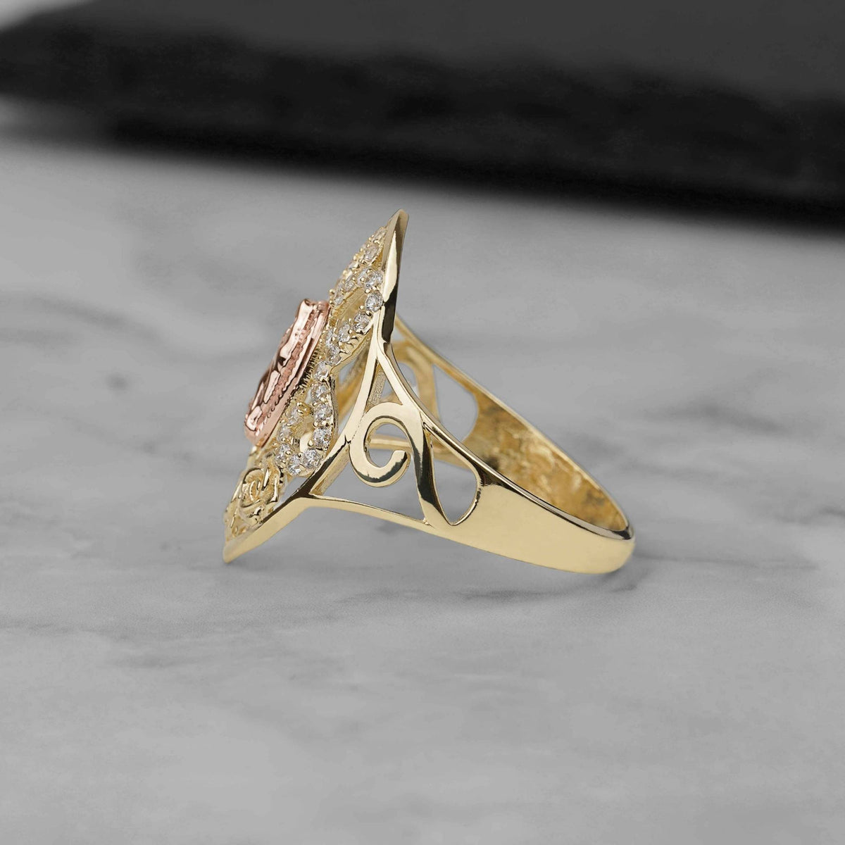 Side profile of the 10k and 14k gold Auron Marquise Virgin Mary ring showing its band details.