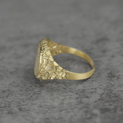 10k - 14k Gold ring with textured band side view on a gray background
