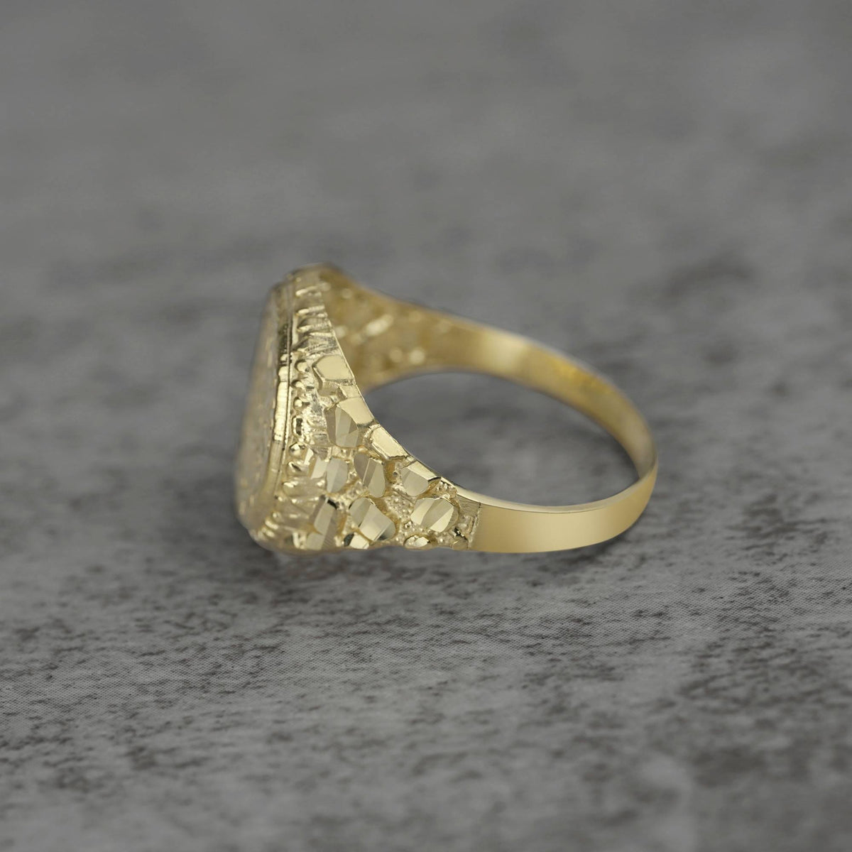 10k - 14k Gold ring with textured band side view on a gray background