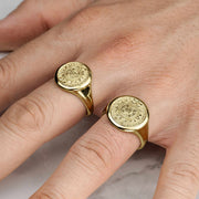Yellow gold classic Aztec Mayan calendar round signet rings lifestyle hand view.