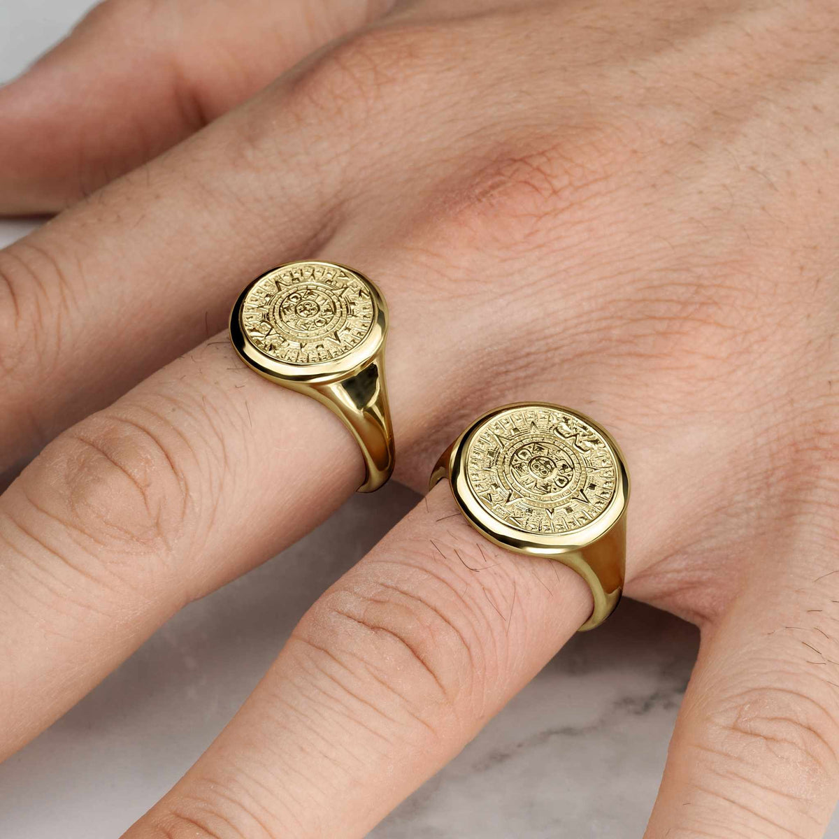 Yellow gold classic Aztec Mayan calendar round signet rings lifestyle hand view.