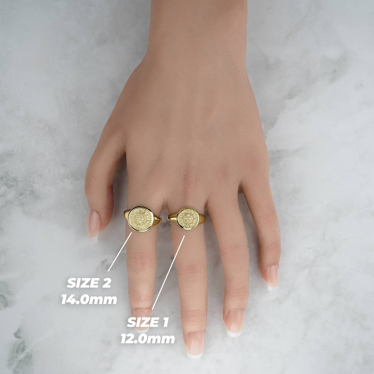 Lifestyle hand view of two gold Aztec Mayan calendar round rings with millimeter labels.