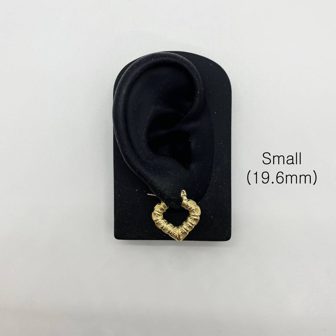 Small 19.6mm gold bamboo heart hoop earring displayed on a black ear model.