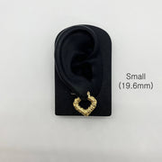 Small 19.6mm gold bamboo heart hoop earring displayed on a black ear model.