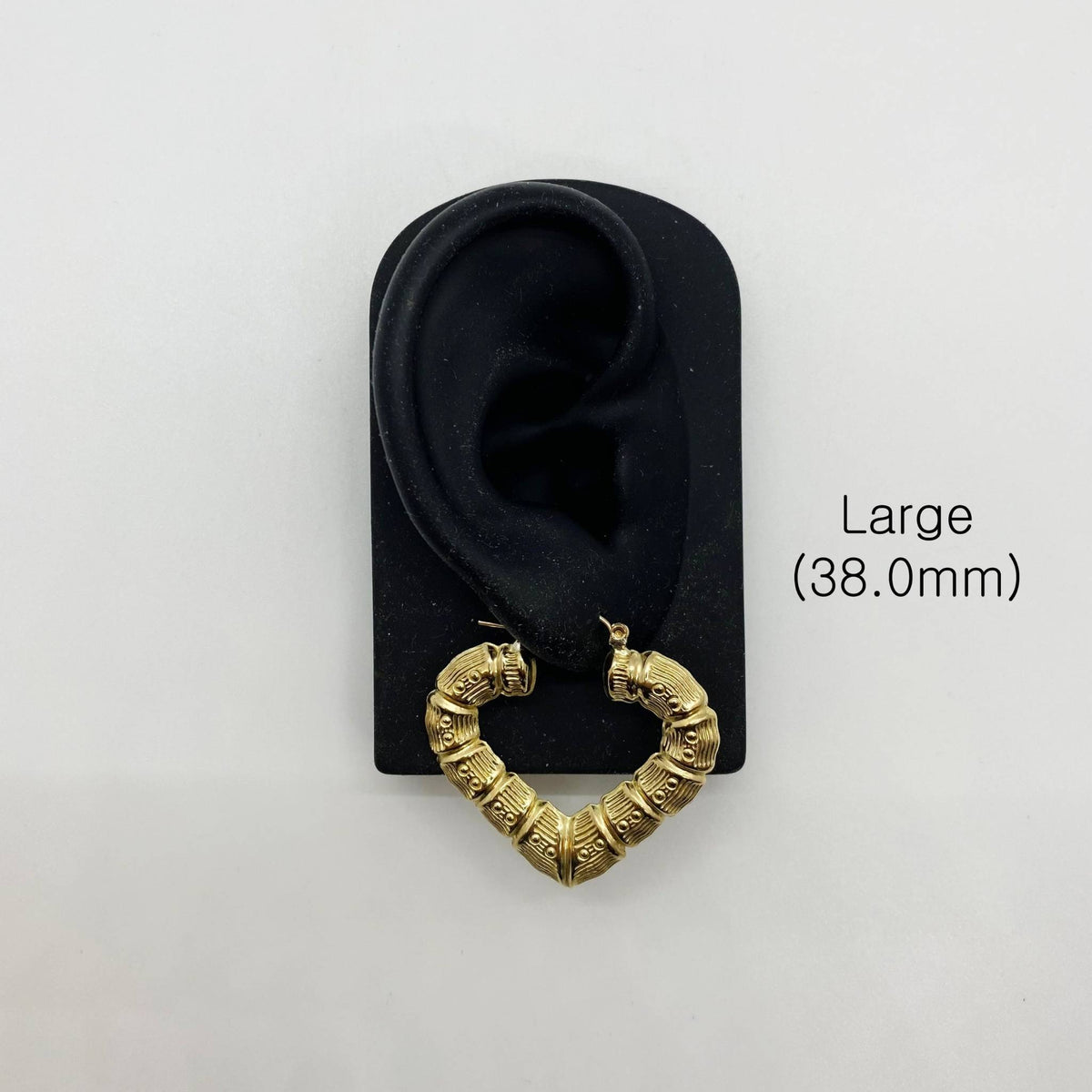 Large 38.0mm gold bamboo heart hoop earring displayed on a black ear model.