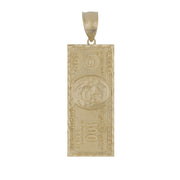 A rectangular gold pendant shaped like a one-hundred-dollar bill with detailed embossing and a bail.