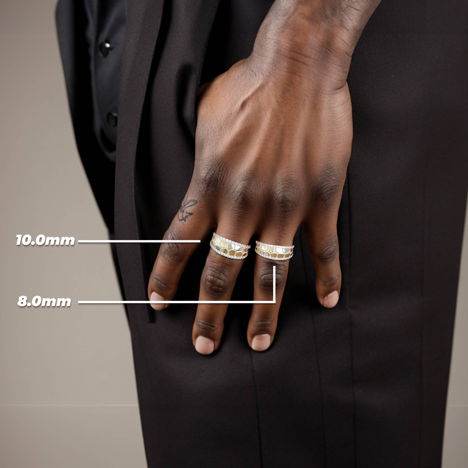 Model showcasing the size difference between 8mm and 10mm gold bling nugget rings.