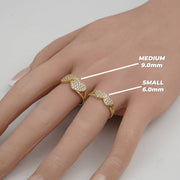 Hand wearing medium 9mm and small 6mm gold dual-heart cubic zirconia rings.